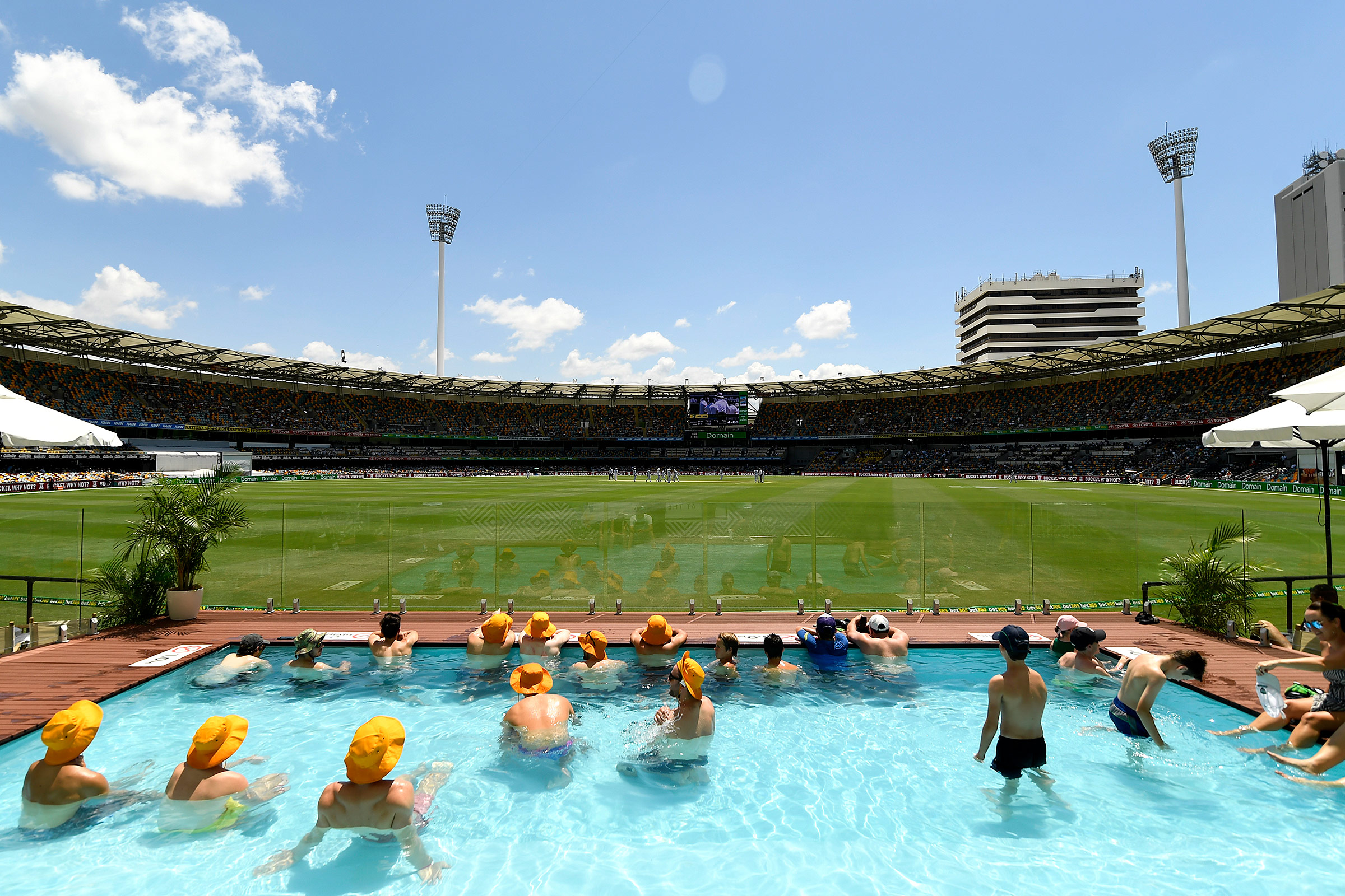 People watching the test cricket in the Gabba pool deck on a hot day